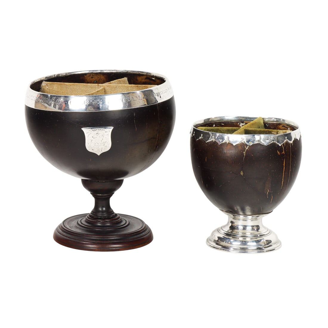 Two English silver mounted coconut cups, 19th century: Two English silver mounted coconut cups, 19th century, the first applied with armorial shield and engraved band inscribed 'This shell was brought from the Island of Carmota by Charles Bertram, and pre