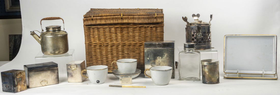 A Drew & Sons 'En Route' System wicker travelling picnic basket: A Drew & Sons 'En Route' System wicker travelling picnic basket, early 20th century, featuring fall front, various monogramed silver plated boxes, enameled trays and cups, spirit kettle and burner, de