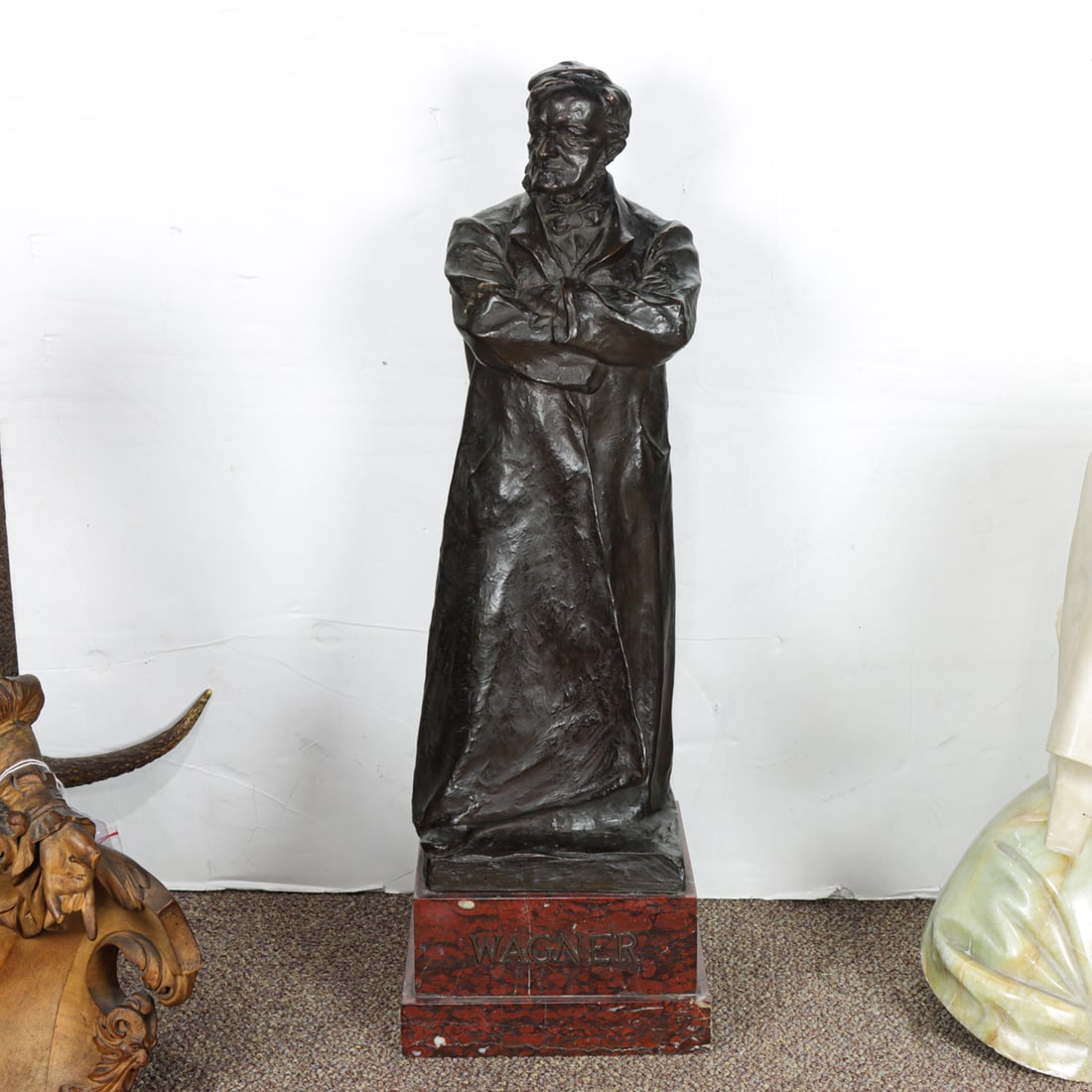 A Continental patinated bronze figure of Wagner: A Continental patinated bronze figure of Wagner, after a model by H. Muller, incised signature, raised on rouge griotte marble plinth with title, overall 26.5"h