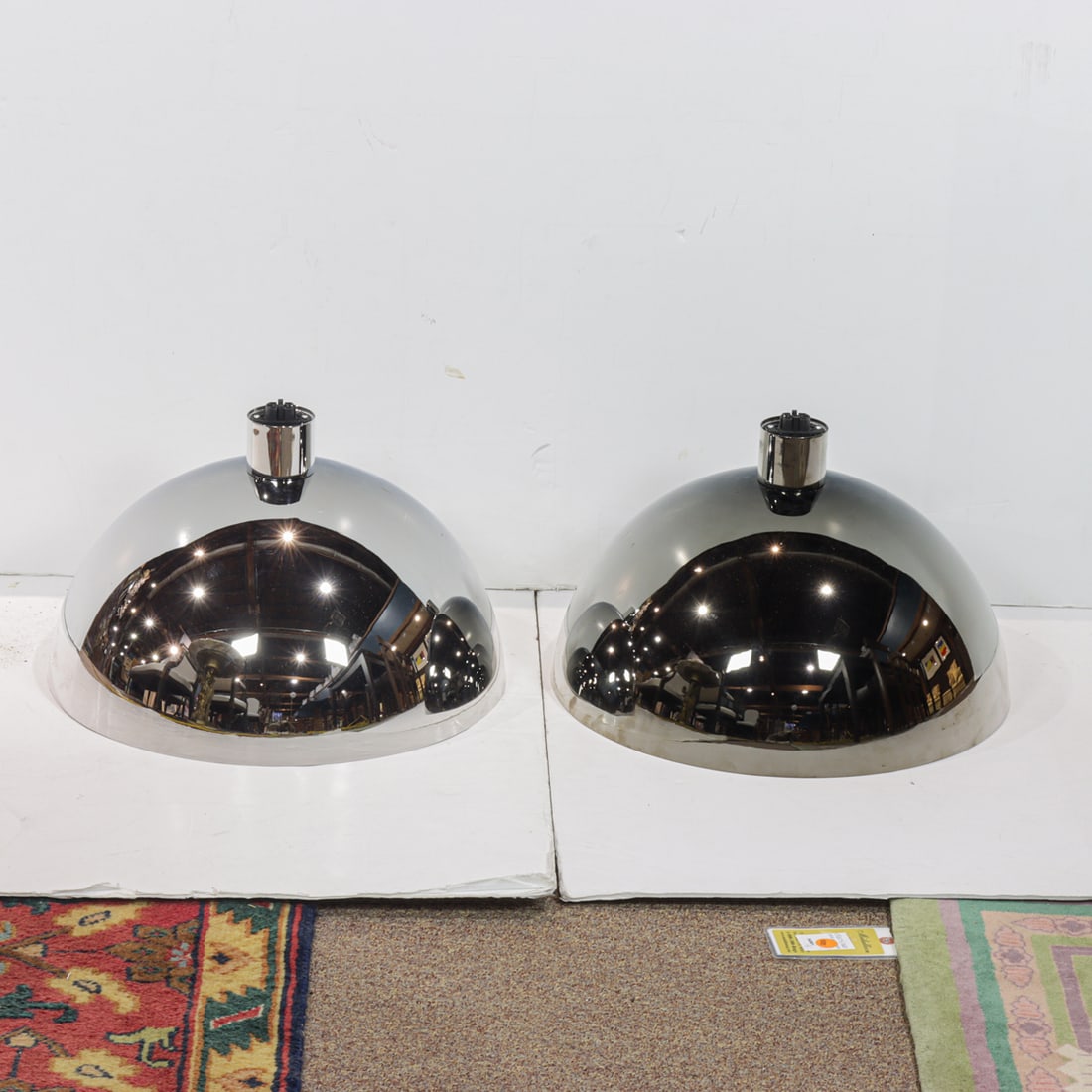 A pair of Italian Modern pendant lights by Nemo: A pair of Nemo Cassina polished chrome 'AM4Z' lights designed by Franco Albini, Franca Helg, and Antonio Piva in 1969, early 21st century production, factory label to sockets, 11"h x 17.75"dia