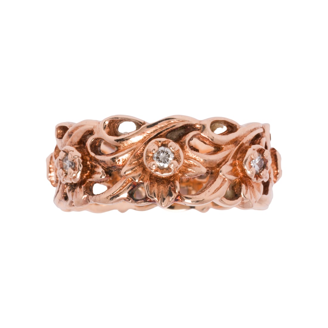 A diamond and 14k rose gold eternity ring: A diamond and 14k rose gold eternity ringOf floral design, set with seven round brilliant-cut diamonds; size 9 1/2; 8.80 grams
