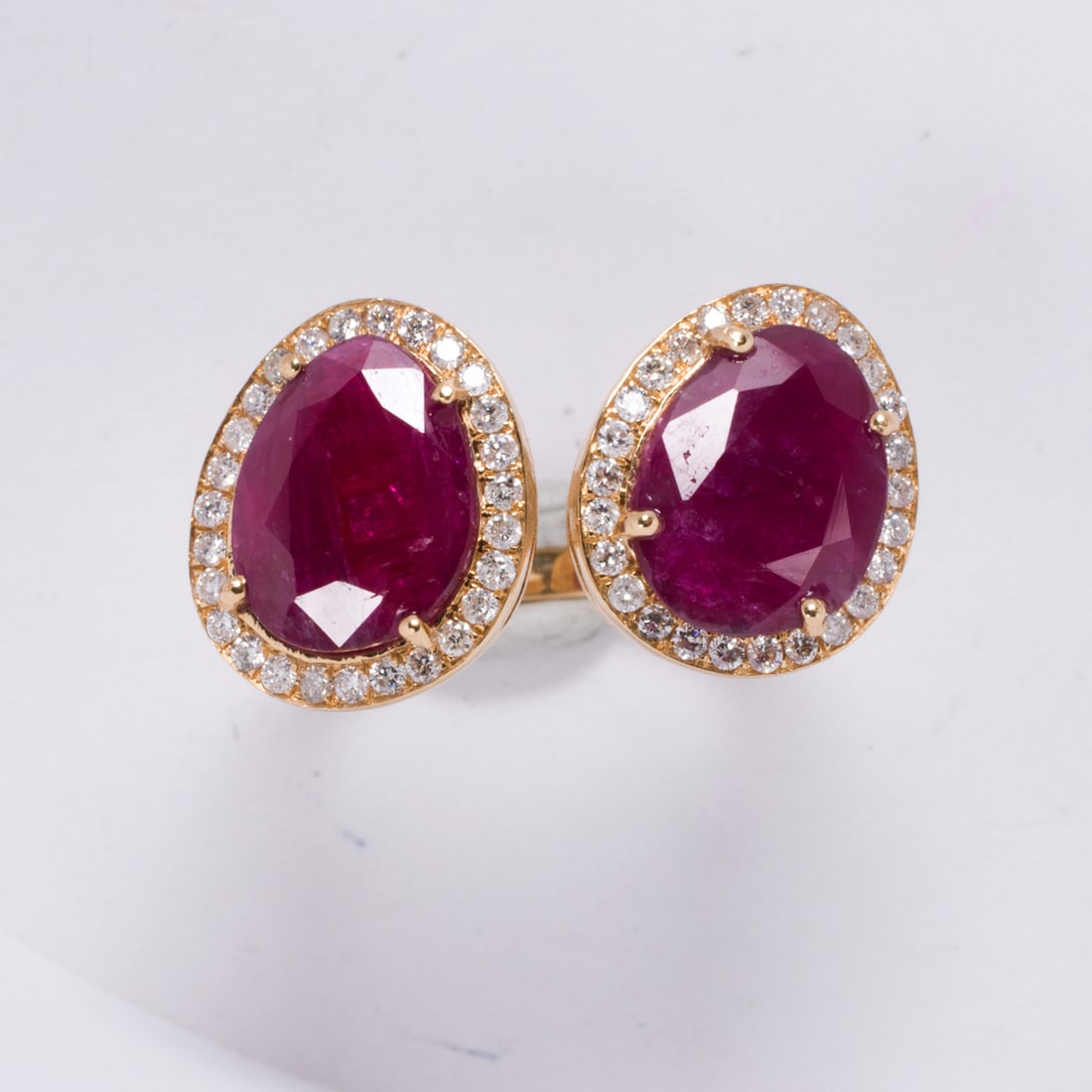 A no-heat ruby, diamond, and 18k gold ring: A no-heat ruby, diamond, and 18k gold ringDesigned with two pear-cut rubies each with round-cut diamond surround; total ruby weight: 4.10 carats; estimated total diamond weight: 0.50 carat; size 7; 4.