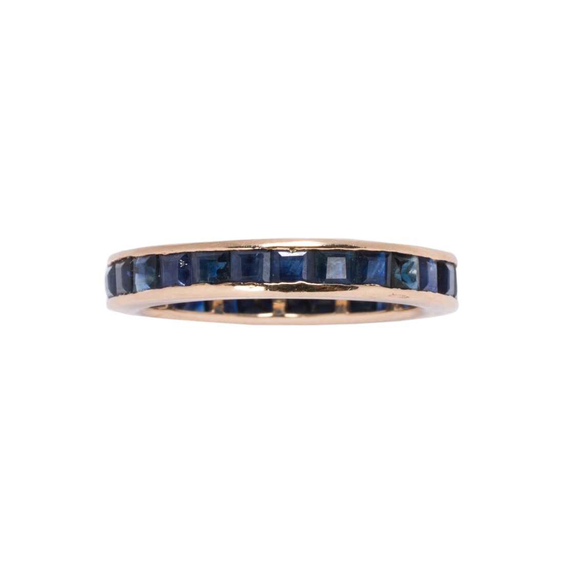 A sapphire and 14k gold band: A sapphire and 14k gold bandSet with numerous square-cut sapphires weighing a total of 2.95 carats; size 6 1/2; 2.75 grams