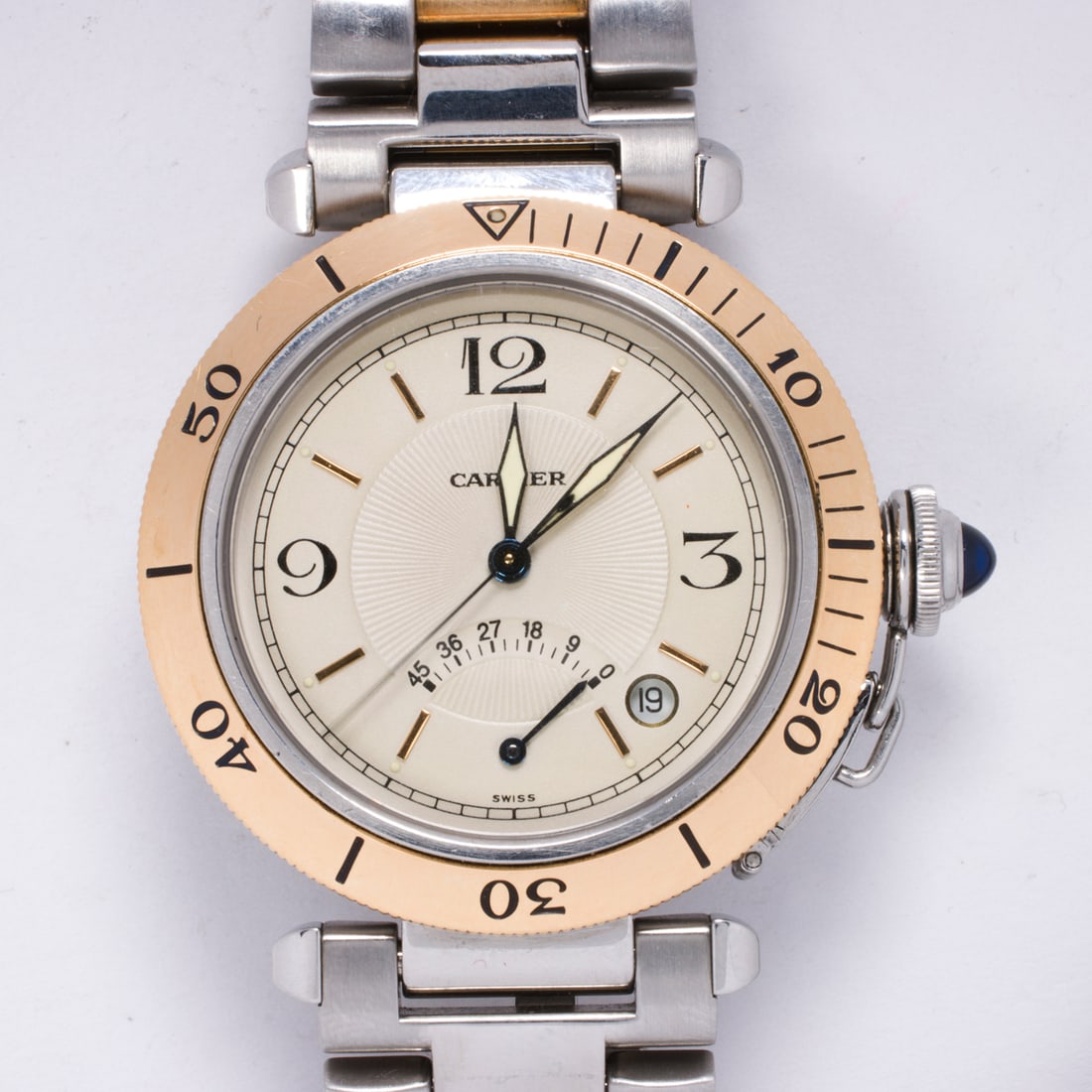 A Cartier Pasha stainless steel and 18k gold watch: A Cartier Pasha stainless steel and 18k gold watchRef: 1033Serial: CC285556The champagne tone face with black Arabic hours, luminous spade hands, date aperture and power reserve, within 18k gold