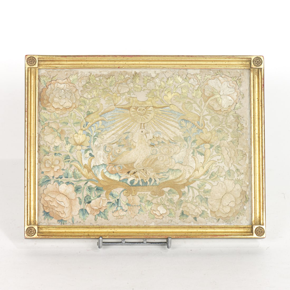 A Continental silk embroidered panel of the Holy Spirit: A Continental silk embroidered panel of the Holy Spirit, 18th century, depicted as a dove beneath the rays of sun, sight 6.75"h x 9.5"w; framed 8.25"h x 10.5"w. . Provenance: The Collection of Adolphu