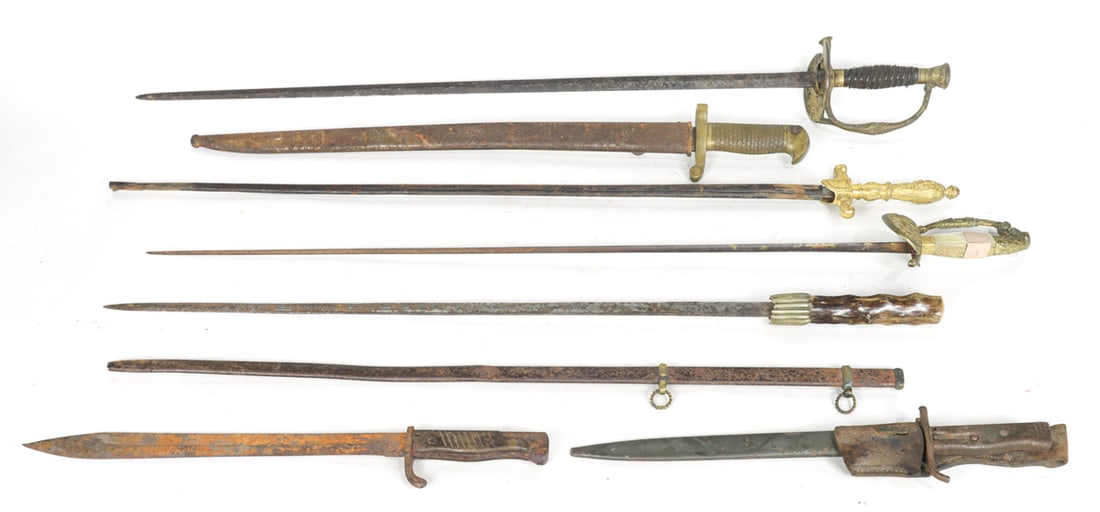A group of swords and bayonets: A group of swords and bayonets, 19th/early 20th century including (2) WWI era bayonets, one with leather holster marked indistinctly 'Luneray 1917'; (1) bayonet with fish scale grip; (3) swords,