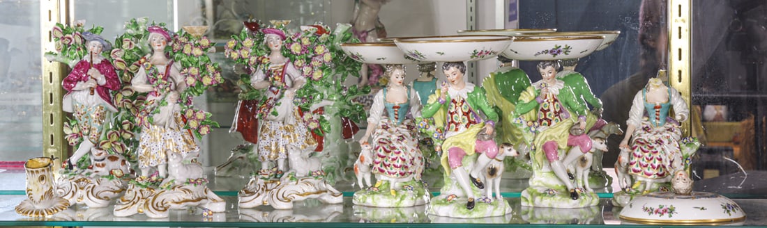 A group of seven Chelsea style or Derby style porcelain figures: A group of seven Chelsea style or Derby style porcelain figures, the first set of three Samson figural candlesticks each modeled as a shepherd or shepherdess before bocage, painted 'France', 9"h and