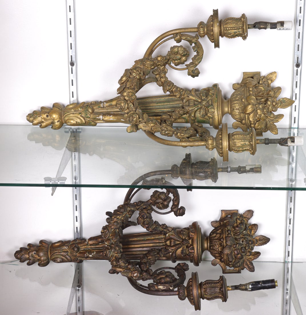 A pair of Neoclassical style giltwood and gesso two light wall sconces: A pair of Neoclassical style giltwood and gesso two light wall sconces, first half 20th century, 22"h x 12"w x 8"d. Provenance: The Collection of Adolphus Andrews Jr. and Emily Taylor Andrews, San