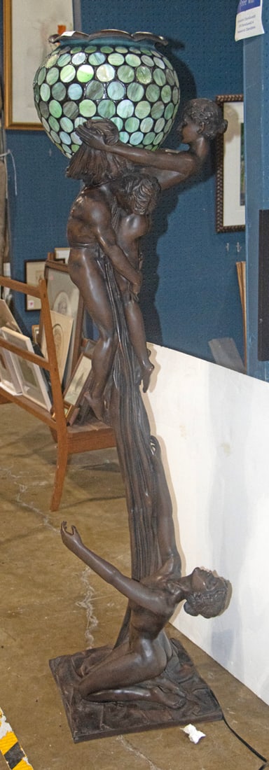 A Contemporary Art Nouveau style patinated bronze and slag glass figural floor lamp: A Contemporary Art Nouveau style patinated bronze and slag glass figural floor lamp, after a model by Gustav Gurschner, depicting a nude male and female figures engaged in a embrace and supporting a