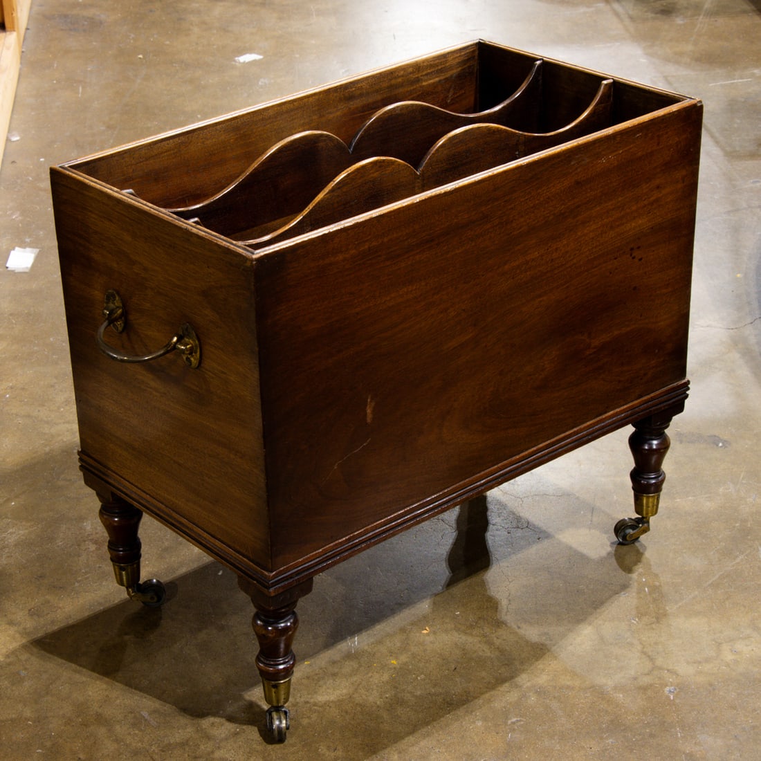 A Georgian style mahogany canterbury: A Georgian style mahogany canterbury, of rectangular outline and raised on turned feet ending in casters, 19"h x 21.25"w x 12"d. Provenance: The Collection of Adolphus Andrews Jr. and Emily Taylor And