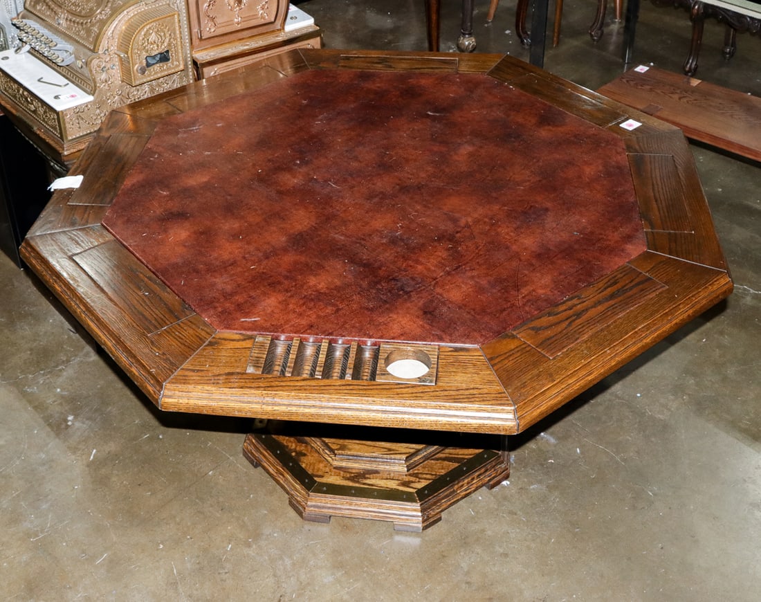 A hexagon shaped oak card table: A hexagon shaped oak card table, table with flip top chip holders and a covered playing surface, 29.5"h x 48" dia
