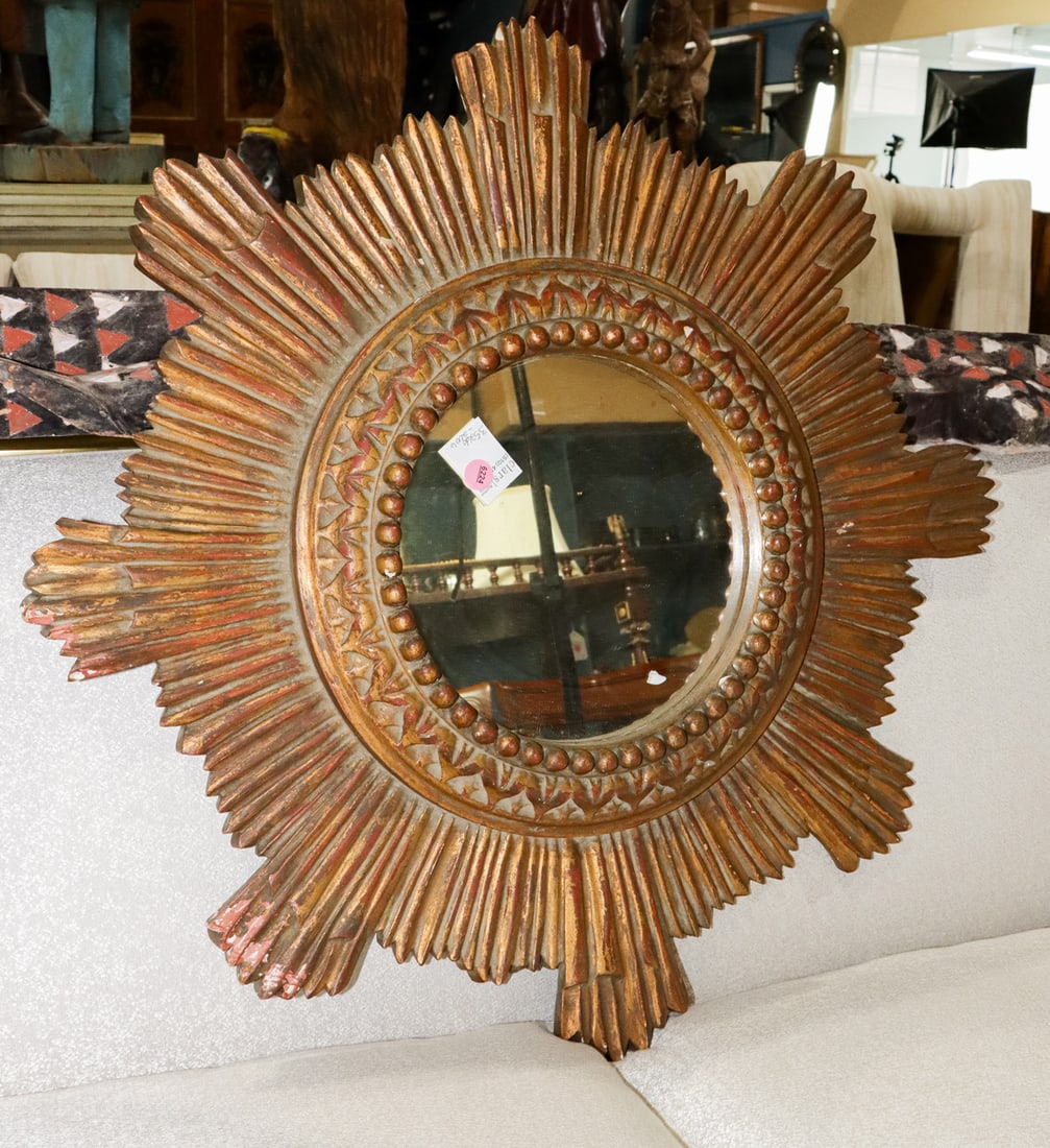 A giltwood sunburst mirror: A giltwood sunburst mirror, 27"dia. Provenance: The Collection of Adolphus Andrews Jr. and Emily Taylor Andrews, San Francisco