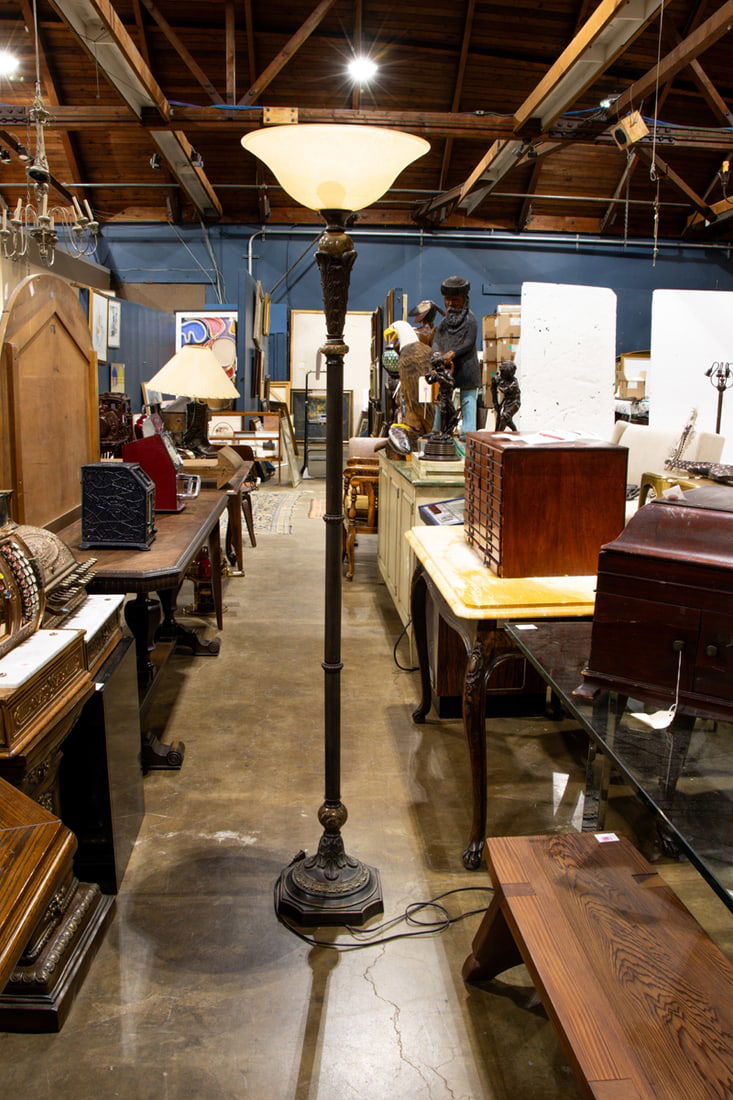 An Art Deco style patinated metal and marble torchiere floor lamp with apricot glass shade: An Art Deco style patinated metal and marble torchiere floor lamp with apricot glass shade, 71"h