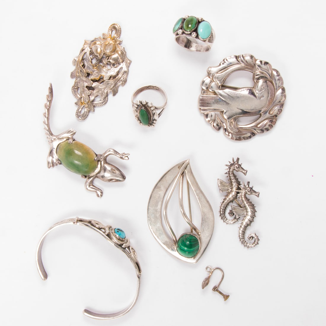A group of silver-tone and sterling silver jewelry including Georg Jensen: A group of silver-tone and sterling silver jewelry including Georg JensenIncluding rings and brooches of varying styles and designs; gross weight: 83.00 grams
