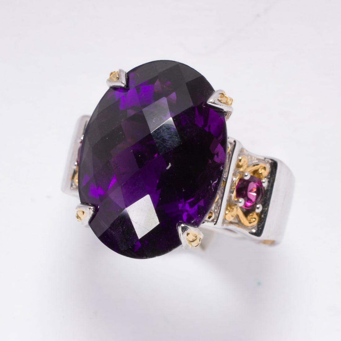 Two costume rings: Two costume ringsOne set with an oval-cut purple stone, one set with numerous round-cut black stones; sizes 7 1/4 and 6, respectively; gross weight: 17.55 grams