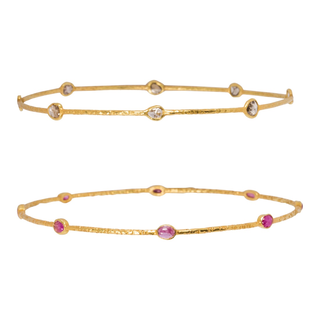 A pair of ruby, diamond and 18k gold bangle bracelets: A pair of ruby, diamond and 18k gold bangle braceletsone set with eight rose-cut diamonds and one with eight oval cabochon rubies; interior circumferences: all 7 1/2 in; 7.40 grams