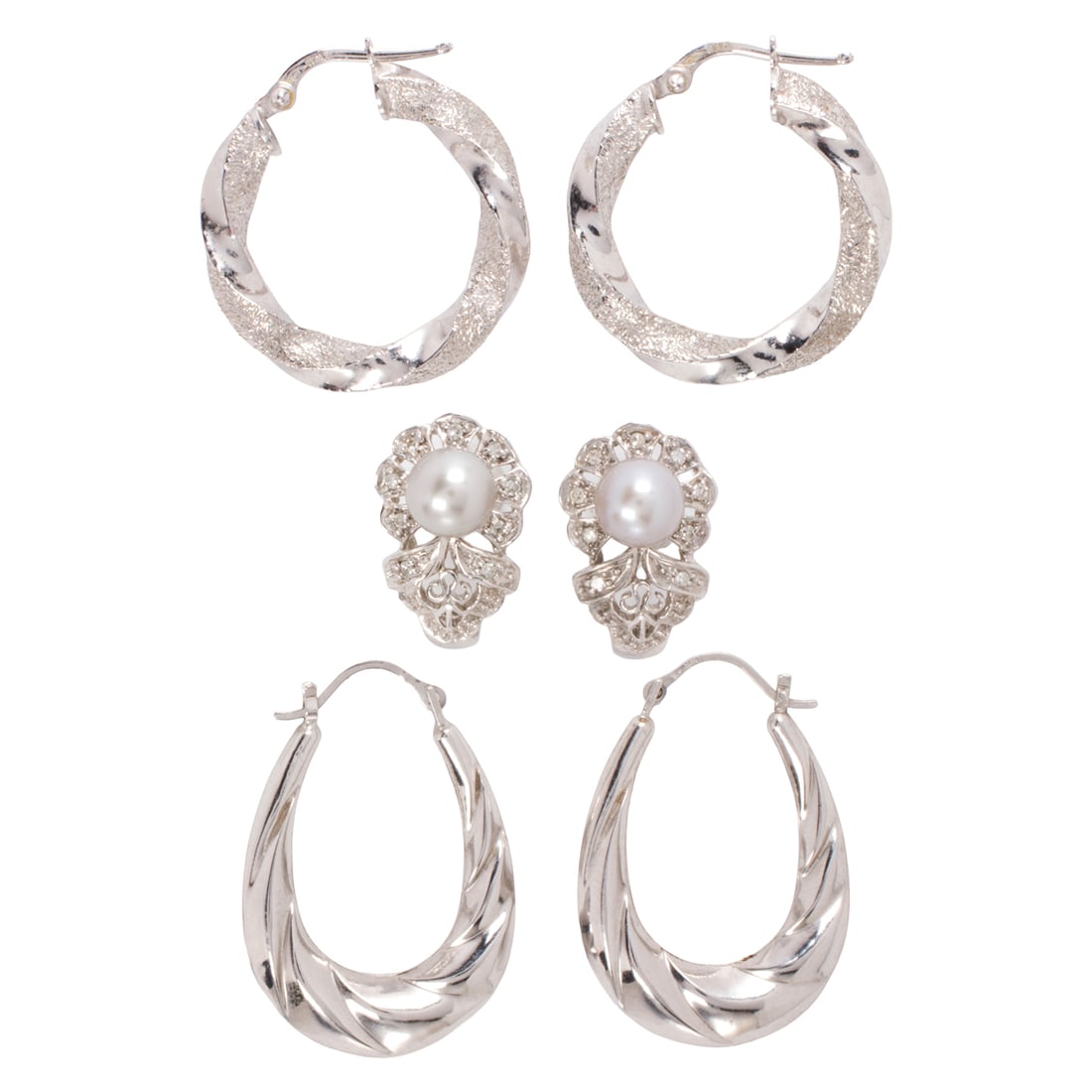 Three pairs of 10k white gold, 14k white gold, and metal earrings: Three pairs of 10k white gold, 14k white gold, and metal earringsComprising one of 10k white gold, one of 14k white gold, and one of silver-toned metal; gross weight: 8.40 grams