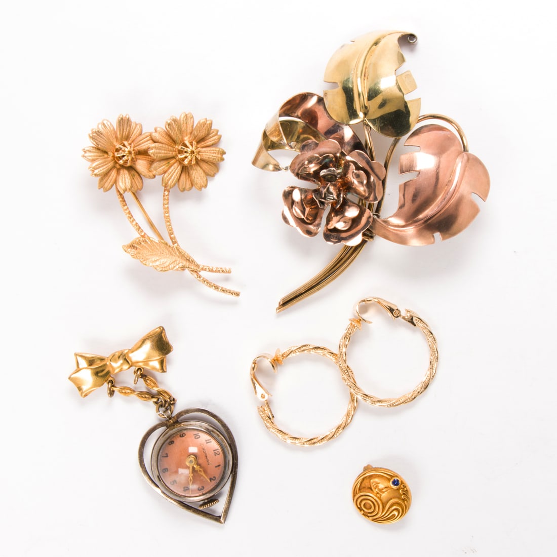 A group of miscellaneous gold-filled accessories: A group of miscellaneous gold-filled accessoriesIncluding a lapel watch and brooches; gross weight: 37.05 grams