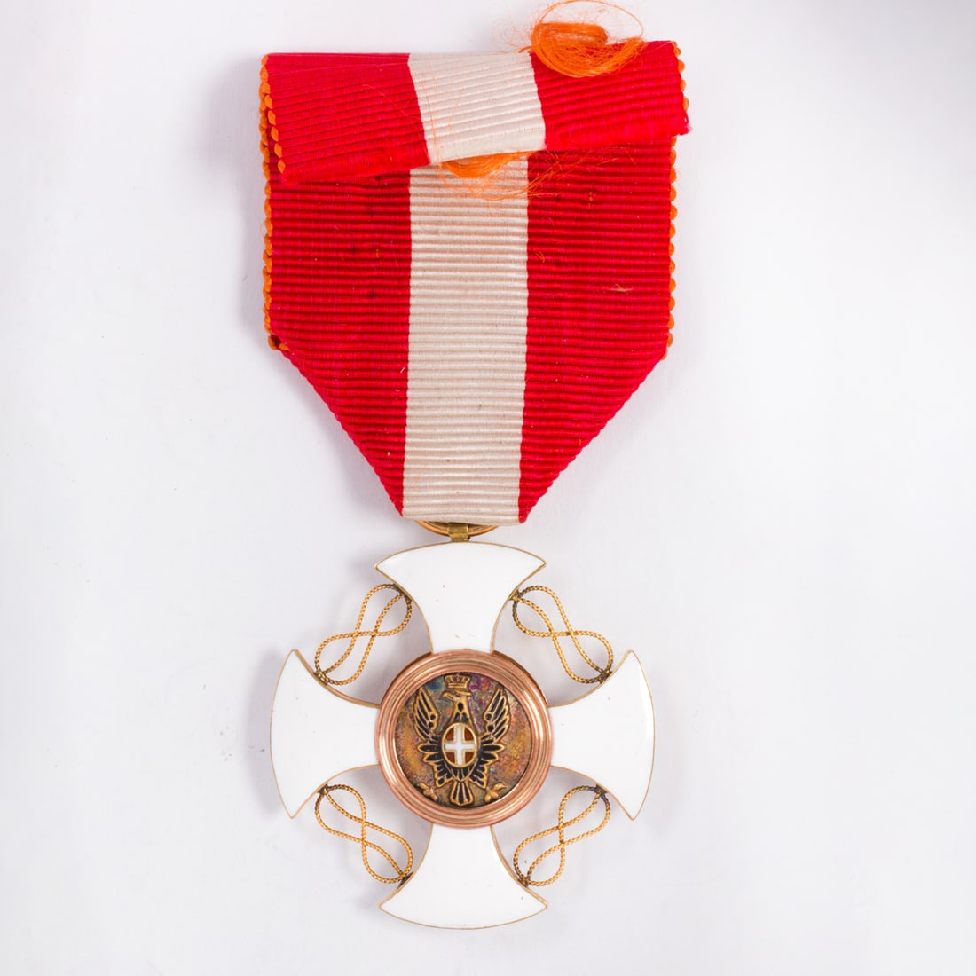 An antique Italian enamel and 14k gold war medal: An antique Italian enamel and 14k gold war medalDesigned with guilloche enamel background, depicting a crown on one side and an eagle on the other, accented by gold filigree; length: 3 1/4 in; 8.80 gr