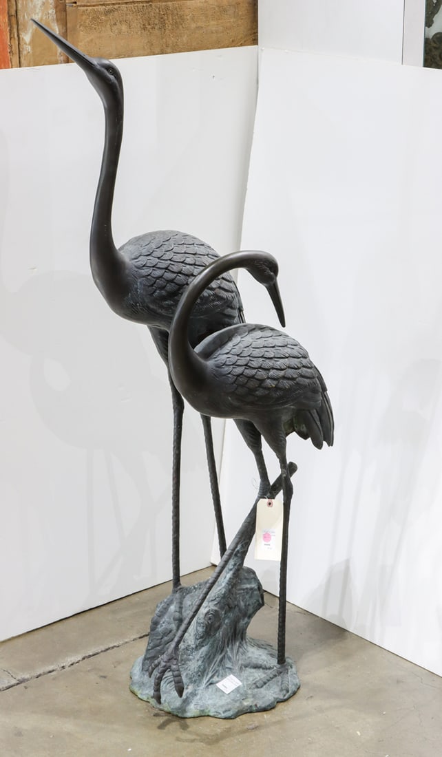 A Japanese patinated bronze garden statue of two cranes: A Japanese patinated bronze garden statue of two cranes. Early 20th century, 54.5" high.