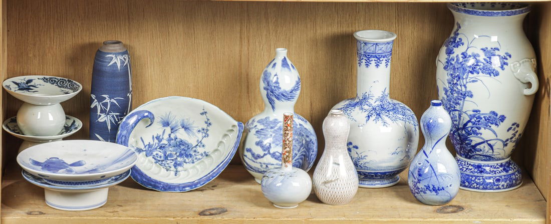 A shelf of Japanese blue and white vases and bowls: A shelf of Japanese blue and white vases and bowls. Meiji period and later, 11.875" tallest.