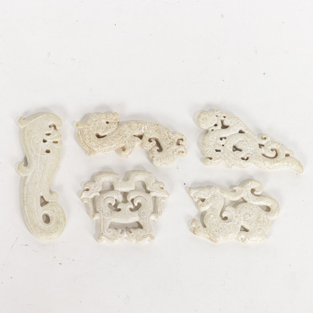 Group of five calcified jade archaistic pendants (1 of 1)