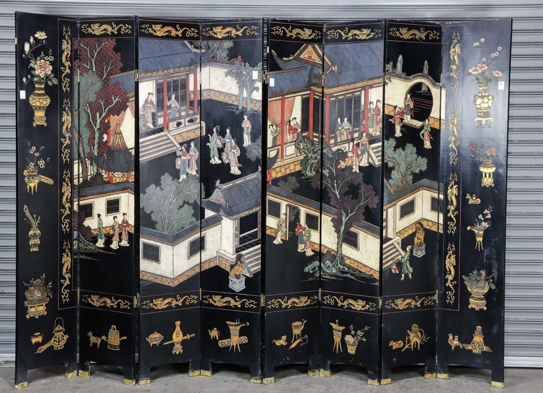 A Chinese eight-panel black lacquer coromandel folding screen (1 of 2)