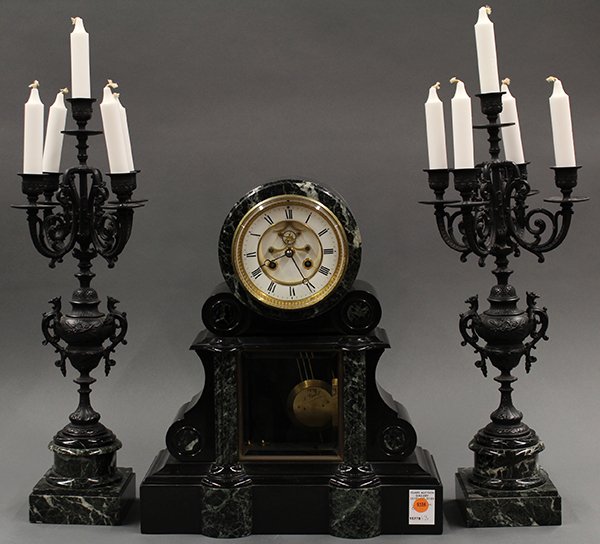 French mixed marble and slate clock with garniture: French mixed marble and slate clock with garniture, the clock having an open escapement with Roman markers 18"h x 15"w x 7"d together with the five light garniture having an urn form standard and risi