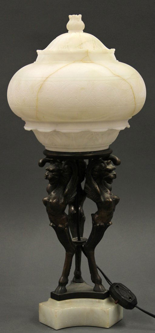 Continental alabaster and patinated bronze table lamp: Continental alabaster and patinated bronze table lamp, executed in the Renaissance taste, the two part alabaster shade accented with incised reserves above the patinated bronze winged griffin support