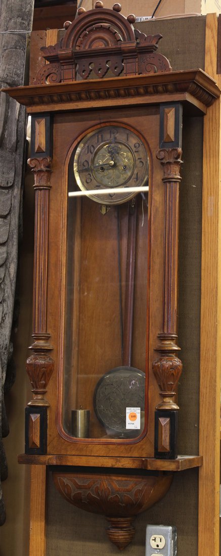 Gustav Becker two weight wall clock, circa 1885: Gustav Becker two weight wall clock, circa 1885. Victorian carved oak case in the Eastlake style, with pilasters and side lights. Brass dial having Roman numerals. Etching on brass inner dial matches