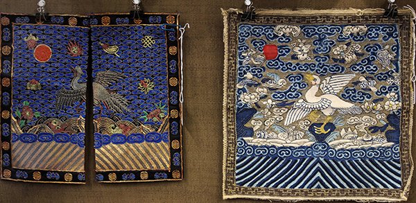 Two Chinese Rank Badges: (lot of 2) Chinese insignia badges, with a pair of front badges couched with a silver pheasant and auspicious emblems amid blue clouds; together with a kesi woven Mandarin duck with the Eight Daoist T