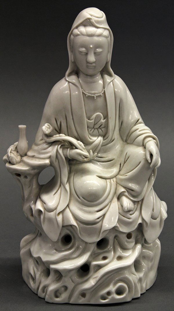 Chinese Blanc de chine Guanyin: Chinese Dehua porcelain figure of Guanyin, seated in royal ease on a perforated plinth, the right arm carrying a ruyi scepter and elbow resting on a platform supporting an amphora, the back impressed