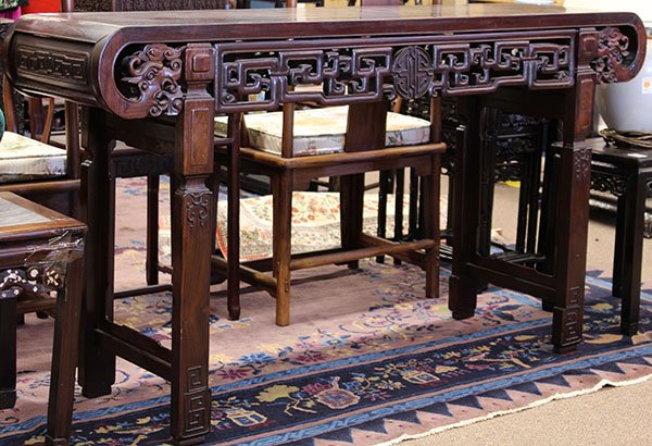 Chinese Wooden Altar Table: Chinese rosewood altar table, the top set with a single floating panel within a plain frame and with the ends scrolling downwards forming dragon form spandrels, while the apron pierced with scrolls an
