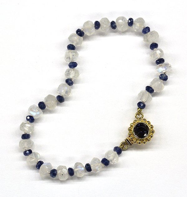 Sapphire moonstone yellow gold bracelet: Sapphire and moonstone bracelet, attributed to Paula Crevoshay featuring faceted rondelle blue sapphires and moonstones, with an eighteen karat yellow gold clasp; 8.9 grams; 7" long