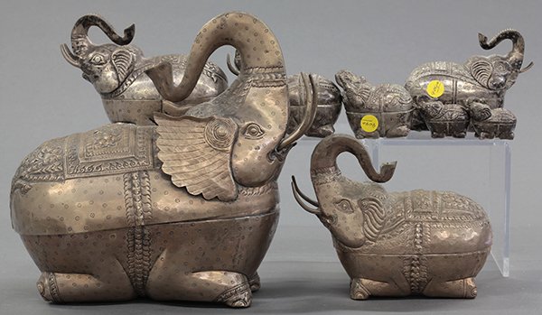 Thai Nesting Silver Elephant Boxes: (lot of 8) Set of nesting Thai/Cambodian elephant form boxes, each with a repousse floral pattern on its back, the smallest six of 925 silver and the two largest of silvered brass, largest: 12.25"h x1