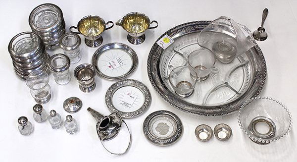 American sterling and glass table articles: (lot of 33) American sterling silver mounted crystal table accessories consisting of coasters, divided serving tray, creamer & sugar, cigarette urns, and shakers; together with a weighted creamer & su