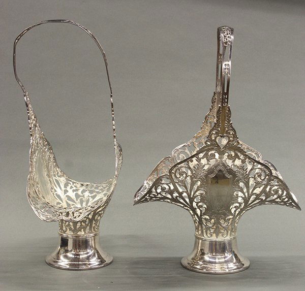 Pair of American silver plate flower baskets: Pair of American silver plate flower baskets by Forbes Silver Company having a reticulated flared form featuring floral and leaf designs, each with bale handle and rising on a circular base, 18"h x 12
