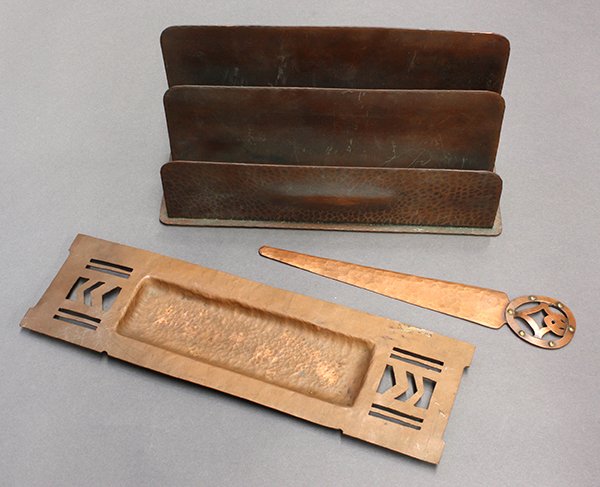 Arts and Crafts copper desk accessories: (lot of 3) Arts and Crafts copper desk accessories including a letter holder marked Berry's Craftshop, 4.75"h 9.25"w 2.75"d; together with a hammered copper letter opener and pen tray