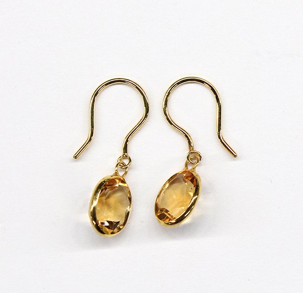 Citrine bezel set drop earring pendants yellow gold: Pair of citrine drop earring pendants in eighteen karat yellow gold, featuring two oval bezel set citrines, weighing in total approximately 4.0 ct.; 1.2 grams