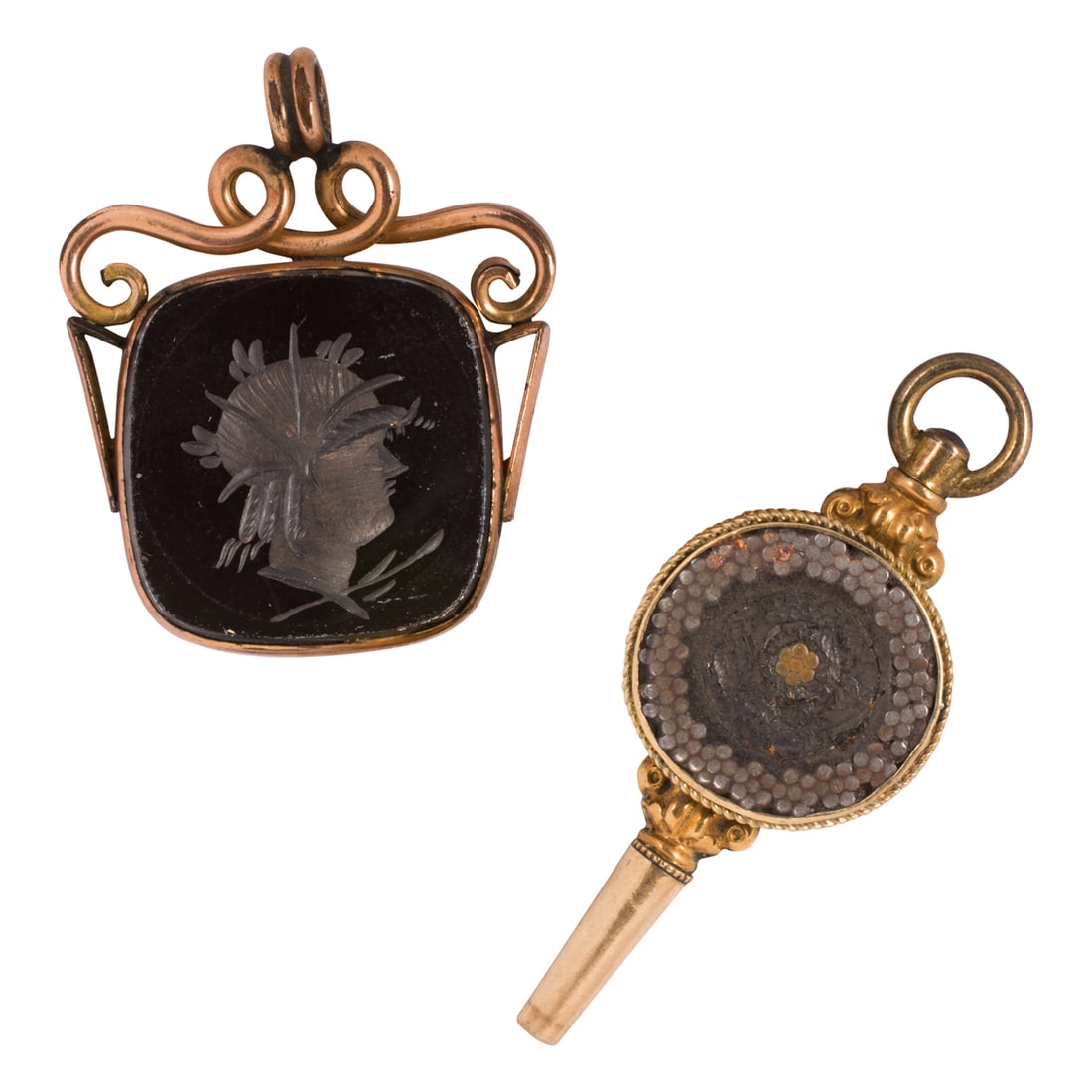 Two antique 14k gold accessories: Two antique 14k gold accessoriesone carnelian intaglio fob pendant depicting a warrior profile, together with a Transatlantic cable souvenier watch key; fob length: 1 1/4 in; key length: 1 3/4 in; gro