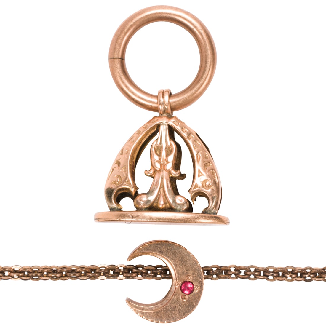 An antique gold-filled watch chain with 12k gold fob: An antique gold-filled watch chain with 12k gold fobComprising a gold-filled pocket watch chain accented by a crescent moon slider, accented by a 12k gold watch fob; chain length: 8 1/2; fob length: