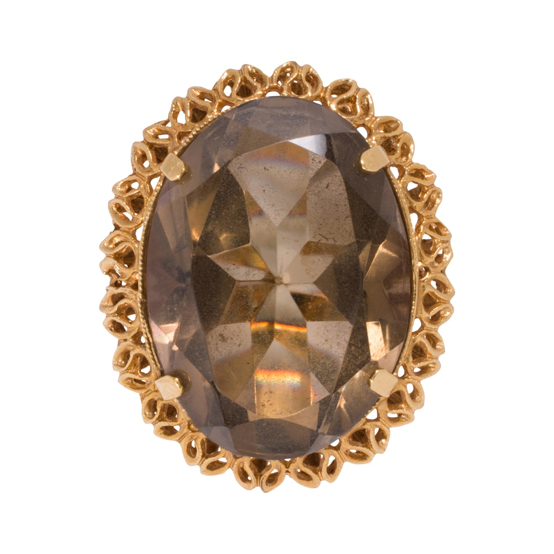 A smokey quartz and 18k gold ring: A smokey quartz and 18k gold ringSet with an oval-cut smokey quartz measuring 25.34 x 18.73 x 11.87 mm, set within ornate textured bezel; size 6; 14.60 grams