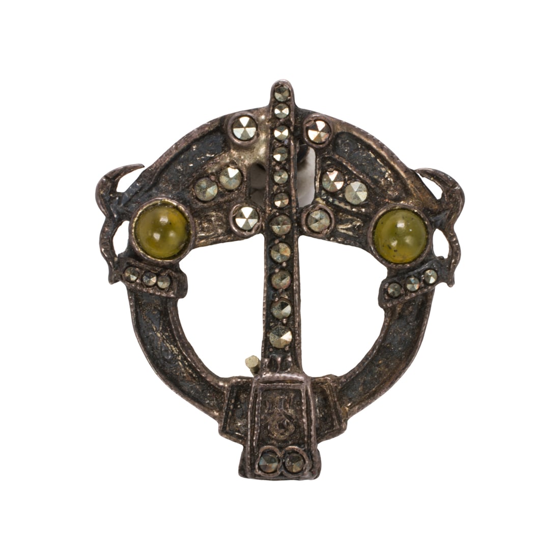 A vintage sterling silver Celtic pin: A vintage sterling silver Celtic pinOf penannular design, set with two round-shaped glass cabochons and marcasite; the verso inscribed with intricate etching; length: 1 in; 5.20 grams