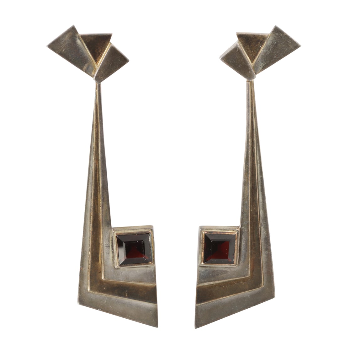 A pair of Erte garnet, 14k gold and sterling silver earrings: A pair of Erte garnet, 14k gold and sterling silver earringsthe pendant earrings of art deco style, with square garnets, striped silver and gold; marked Erte CFA AP 1979; length: 2 7/8 in; 13.36 grams