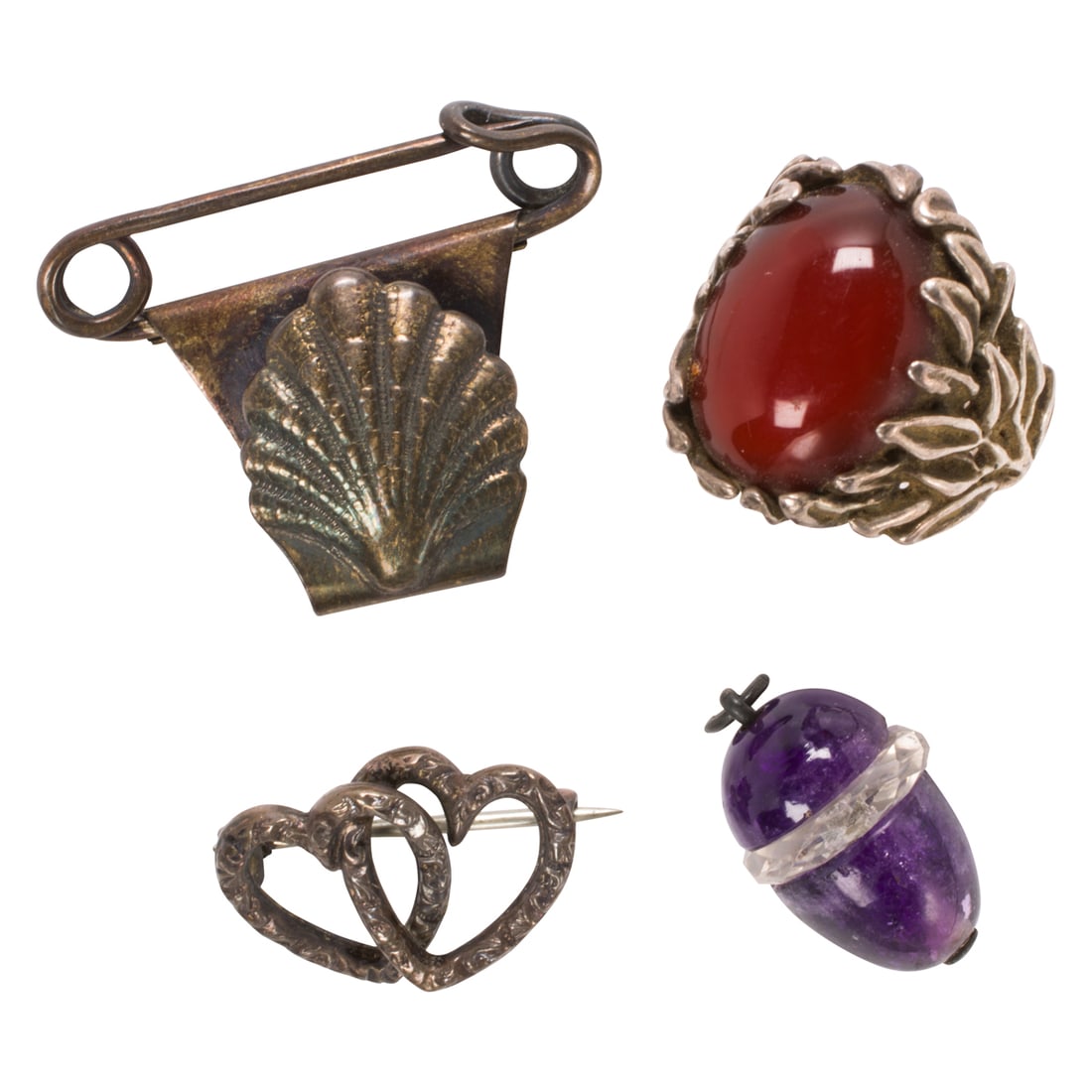 Four antique silver accessories including Shiebler: Four antique silver accessories including ShieblerComprising one Shiebler shell pin, one heart pin, one carnelian and sterling silver ring, and one silver, quartz and amethyst acorn pendant; pin
