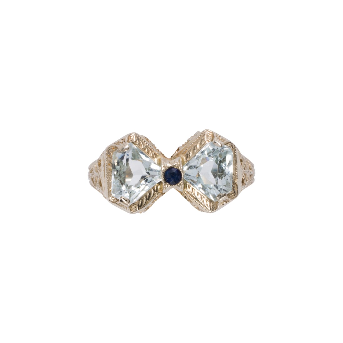 An Art-Deco aquamarine, sapphire, and platinum bowtie ring: An Art-Deco aquamarine, sapphire, and platinum bowtie ringDesigned as a bowtie, set with two modified shield-cut aquamarine measuring approximately 4.91 x 6.32 x 2.92 mm, accented by one round-cut