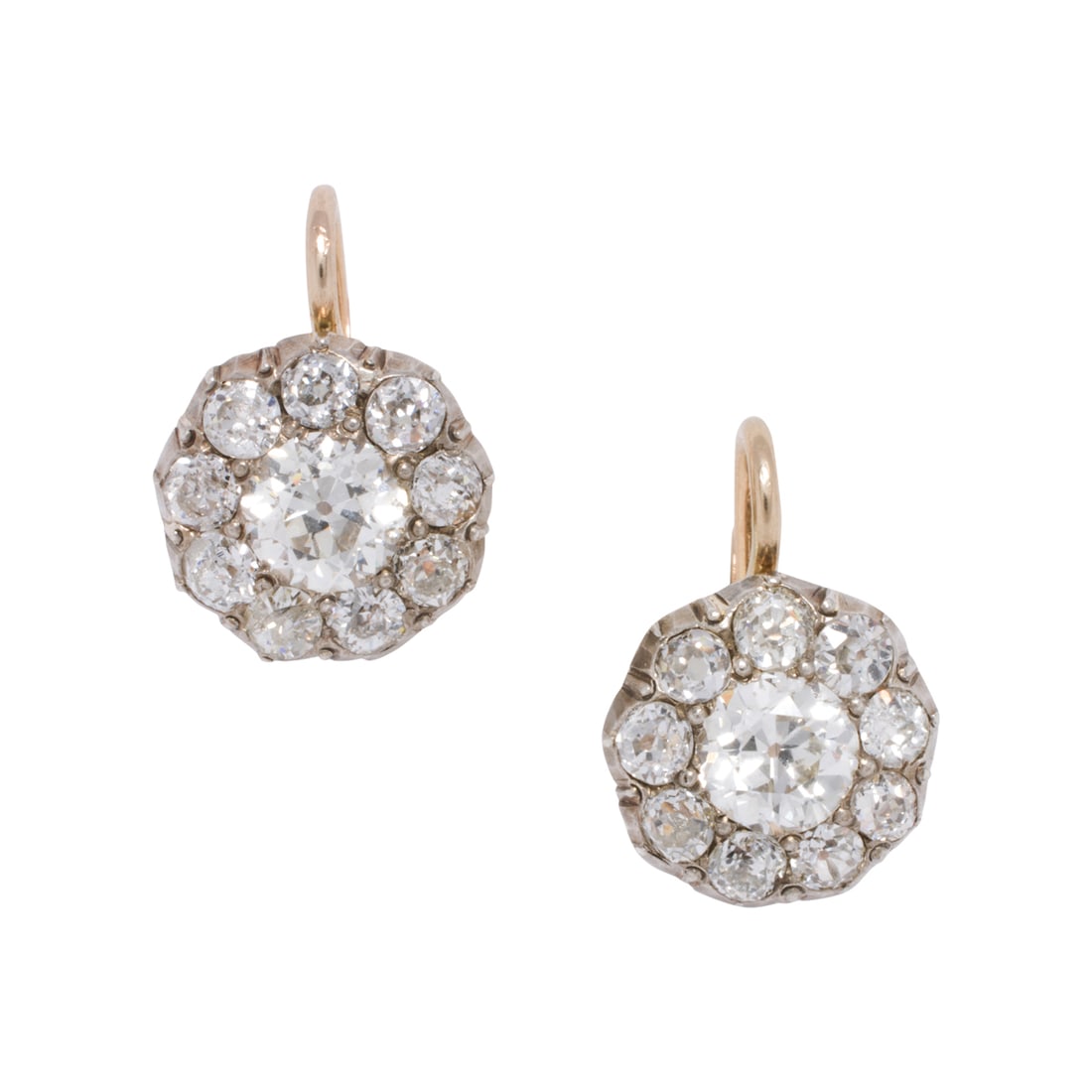 A pair of antique diamond and silver-topped 14k gold earrings: A pair of antique diamond and silver-topped 14k gold earringseach centering an old mine-cut diamond weighing approximately 0.55 carat, surrounded by nine old mine-cut diamonds; estimated total