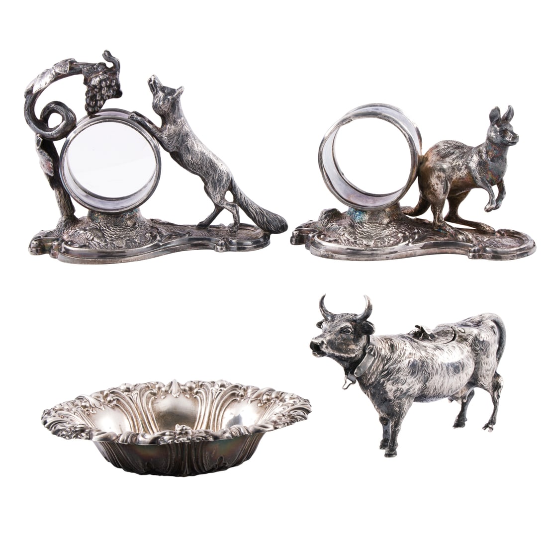 An 800- Silver Cow Creamer with Other Animal Figural Table Articles: An 800-silver cow creamer with others, comprising (1) 800-silver cow creamer, 3.25"h x 5.5"l; (1) small Frank M. Whiting sterling repousse bowl, 5.125"dia; (2) silverplate animal figural napkin