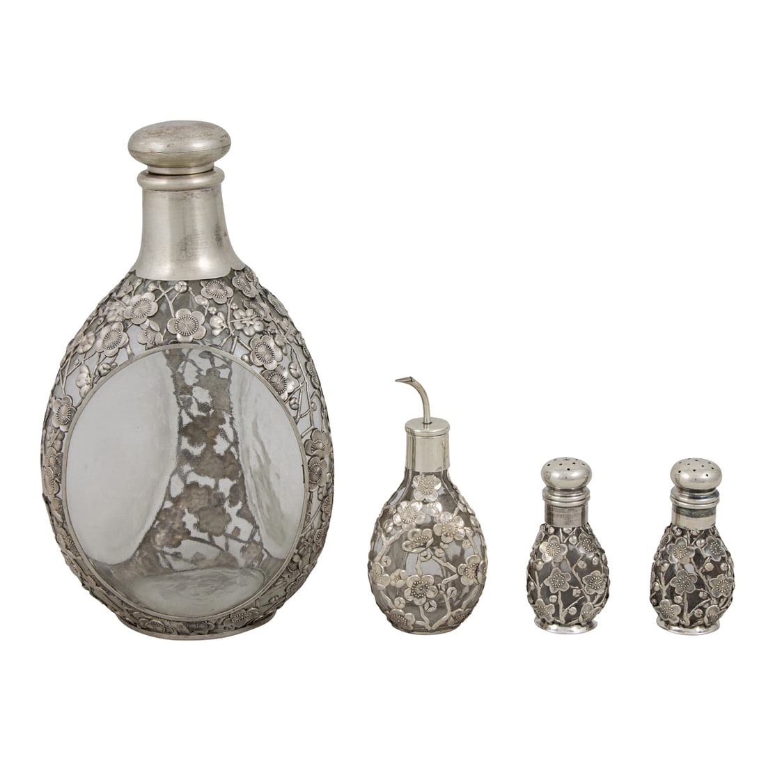 Four pieces of Chinese export 950- silver overlaid table articles: Four pieces of Chinese export 950- silver overlaid table articles in a cherry blossom pattern, comprising a decanter, a pair of salts and an oil dispenser. The decanter 8.5"h; the pair of salts, 3"h;