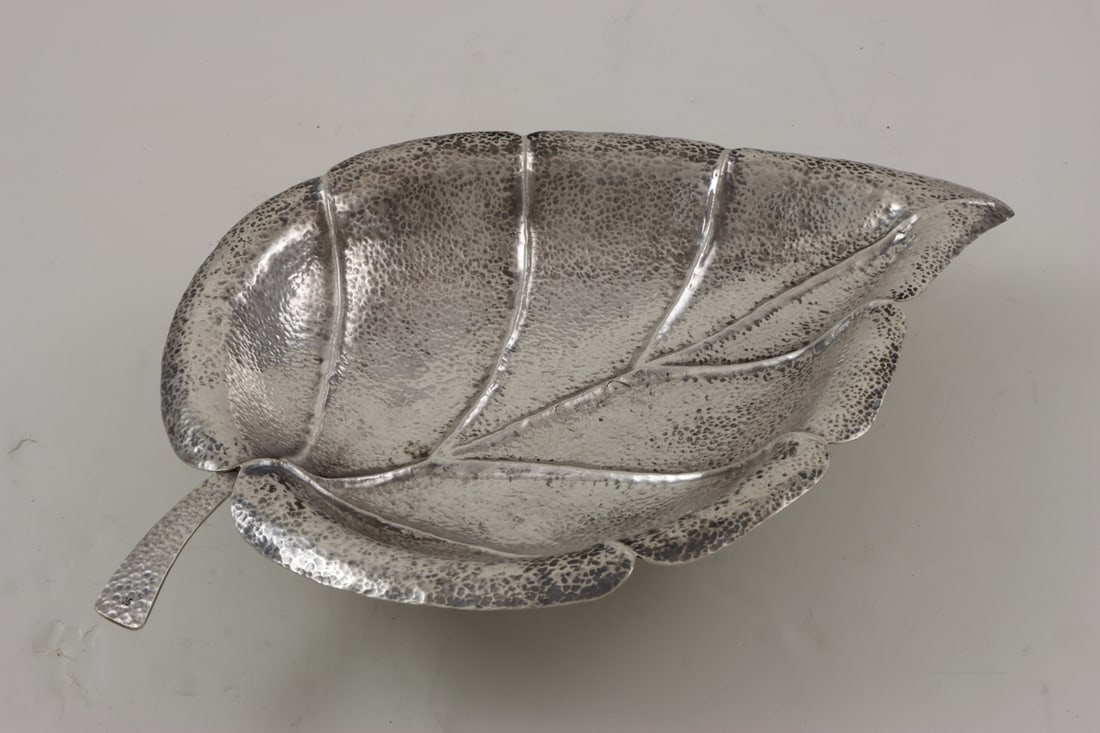 A 900-Silver Leaf Form Bowl: A 900-silver leaf form bowl raised on ball feet, the hammered bowl, 16"l, 21.32 troy oz